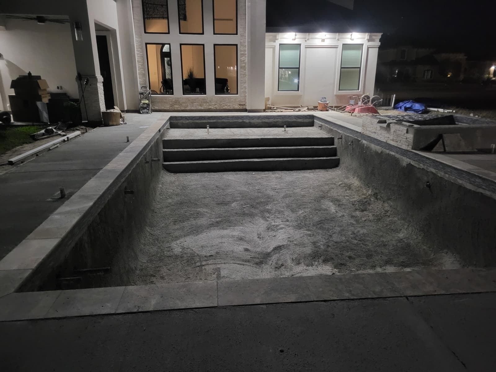 Freshly plastered pool shell with steps, ready for water
